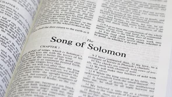 Close Up Shot of  Bible Page Turning to the book of Song of Solomon