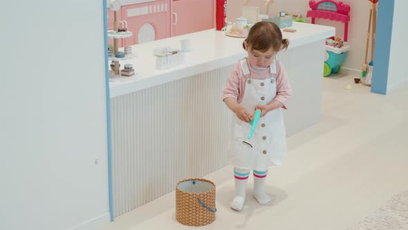 2-year-old Little Girl Playing And Reeling Fishing Rod Toy At Kids Cafe. - static