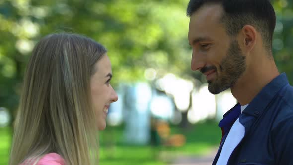 Man With Bouquet of Tulips Watching His Girlfriend Flirting With Another Man