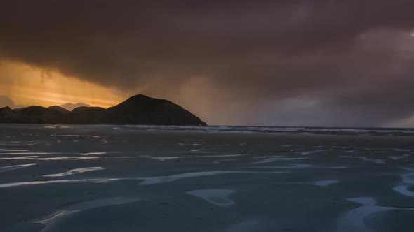 Rainy clouds in sunset over beach