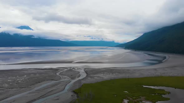 4K Cinematic Drone Video (truck left) of Mountains Overlooking Turnagain Arm Bay at Low Tide Near An