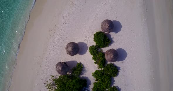 Natural above abstract shot of a white sand paradise beach and aqua blue water background in colorfu