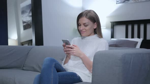 Woman Text Messaging on Smartphone Browsing Internet