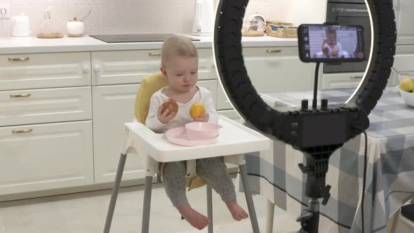 Parents Record Video on Smartphone of Kid in High Chair at Home Recording with Mobile Phone and Ring