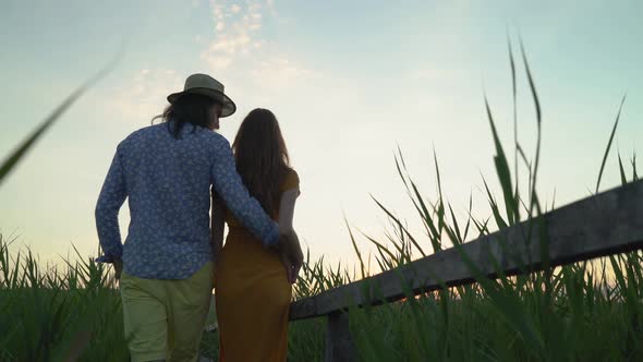 Rear view of a couple walking alt