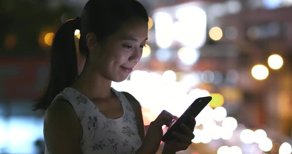 Woman use of mobile phone at night 