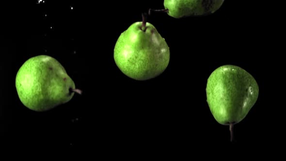 Super Slow Motion Green Pears Fall on the Water with Splashes