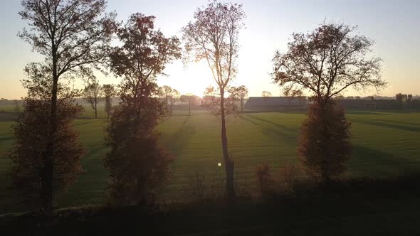 AERIAL View with LENS FLARE Picturesque Shot of Golden Autumn Sunbeams Illuminating the Colorful