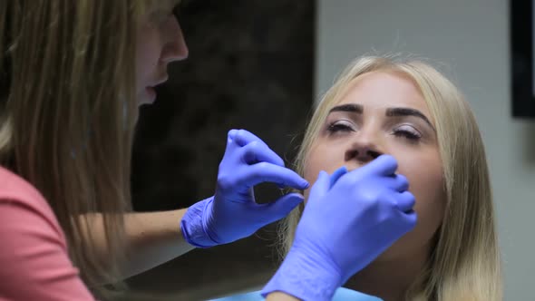 Teeth whitening procedure, dentist - Close-up of patient