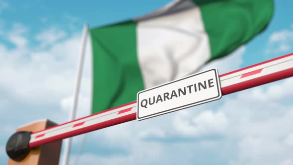 Opening Barrier with QUARANTINE Sign Against the Nigerian Flag