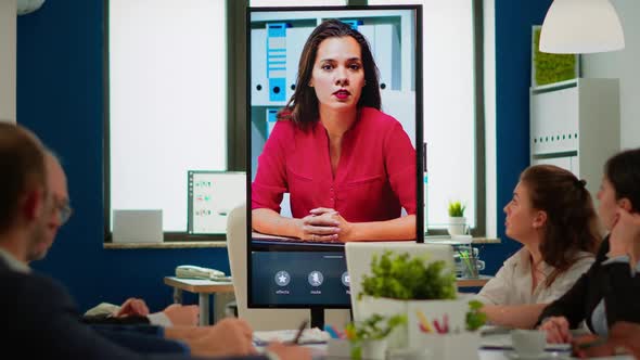 Diverse Team of Coworkers Talking with Project Manager Using Web Cam