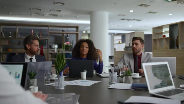 Multiethnic Financial Team Meeting Researching Business Strategy in Workplace