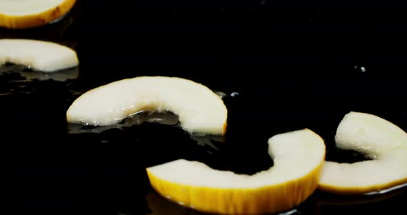 Slices of Melon Fall on the Water Splashes. 