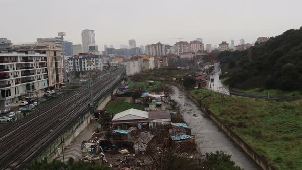 Trains Travelling On Railway Track Along Slums And Apartment Buildings Near Stream In Maltepe Distri