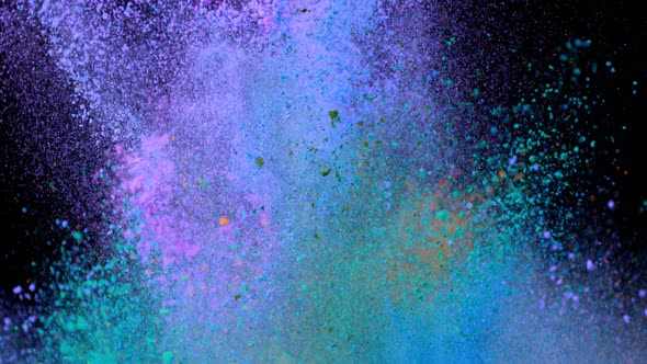 Super Slowmotion Shot of Color Powder Explosions Isolated on Black Background alt