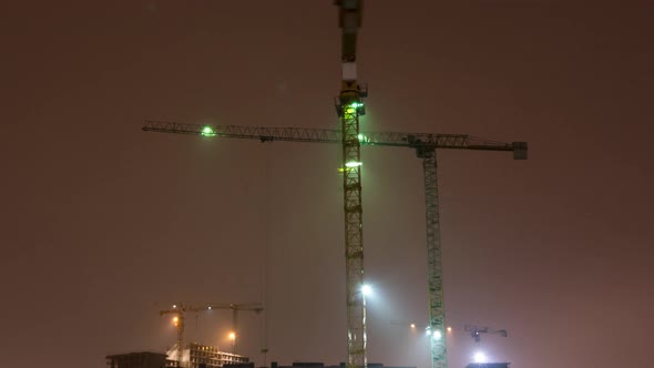 Construction site with crane night time lapse. Building of skyscrapers.