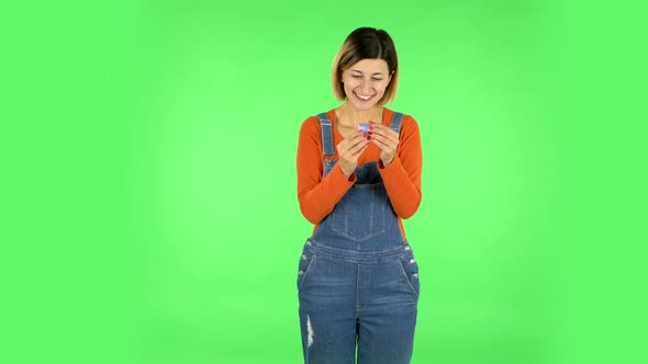 Girl Opens a Small Box with a Surprise and Is Very Disappointed with What She Saw. Green Screen