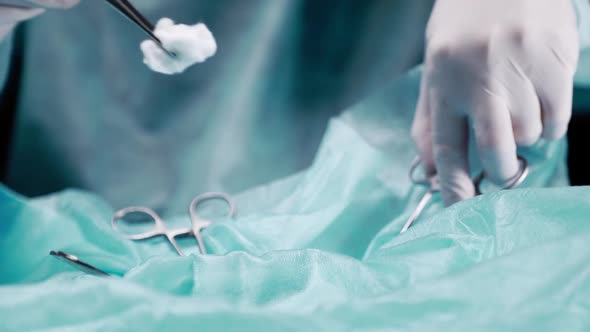 Doctor Performs a Closeup Operation. The Doctor Holds Tweezers with Tweezers and Processes the
