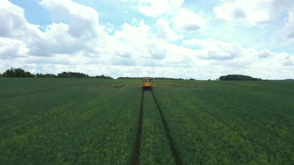 Aerial view of farming tractor crop sprayer in the countryside