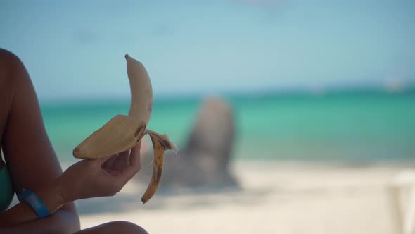 Girl Hand Holding Peeling And Eating Banana. Healthy Food Fruit Vegan Vitamin Concept.