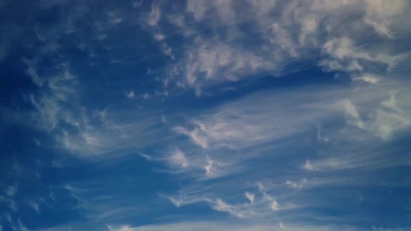 Beautiful clear blue sky turns dark soft cloud timelapse during sunset.