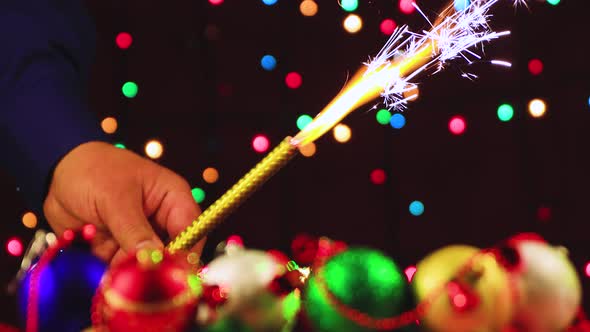 New Year's Video Screensaver of a Man's Hands Holding a Burning Fireworks