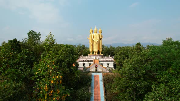 Aerial drone of Golden Wat Doi Sapanyoo with a large staircase leading to four unique buddha statues