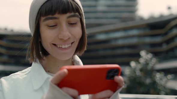 The Woman with Smile on Face is Watching Video on Smartphone
