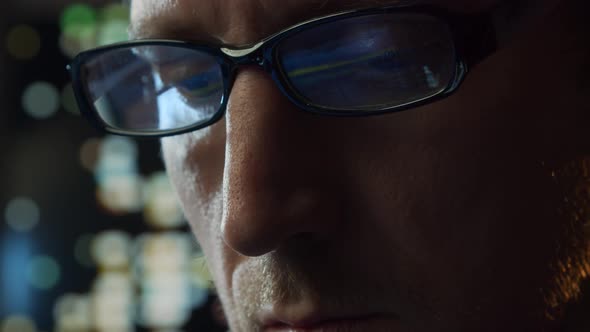 Close-up portrait of a young man working at the computer.