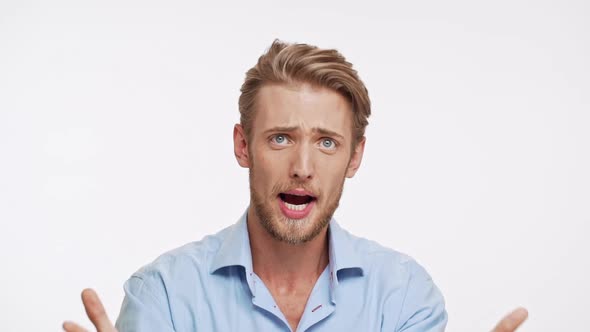 Disappointed Caucasian Male with Blue Eyes and Brown Beard Asking Why on White Background in