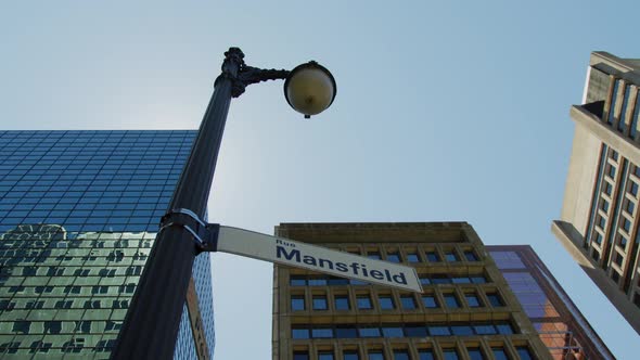 Light pole with street signs, in Montreal