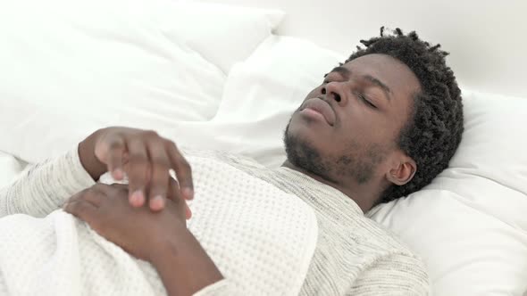 African Man Having Headache in Bed