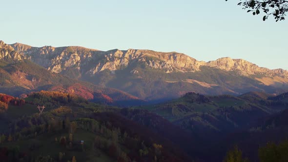 Scenery Of Limestone Ridge With Dense Forest Autumn Trees Under Bright Sky In Piatra Craiului, Braso