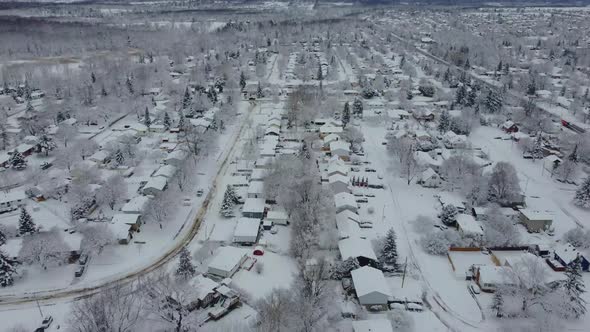 Aerial snow covered neighborhood during a overcast winter day