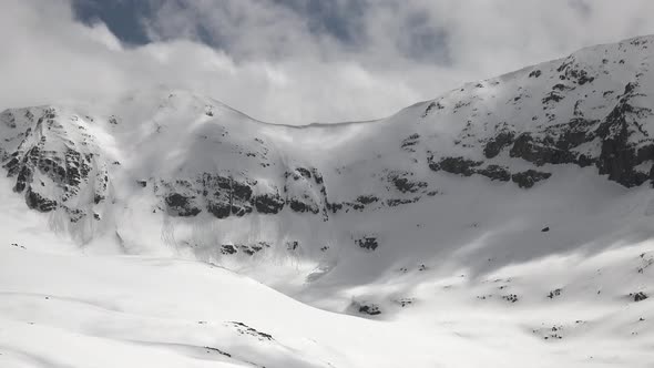 High Altitude Rocky Snowy Mountain Ridge in Winter