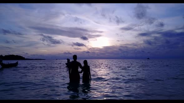 Teenage lovers happy together on tranquil coastline beach time by blue ocean with white sandy backgr