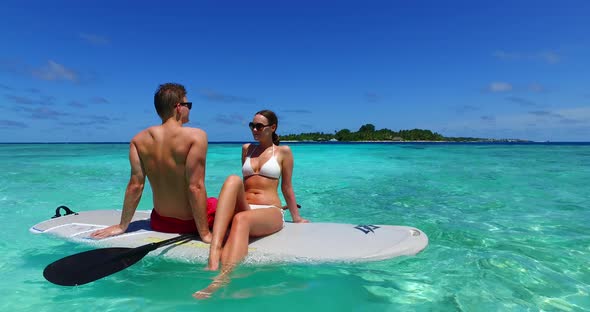 Young people on romantic honeymoon enjoy luxury on beach on white sand background 4K