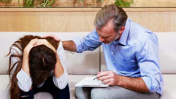 Doctor consoling female patient