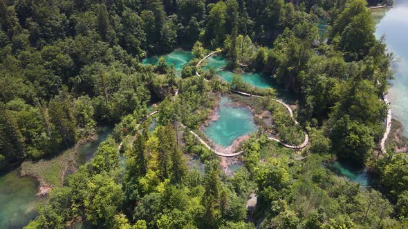 Top view of the Plitvice Lakes National Park with many green plants and beautiful lakes and waterfal