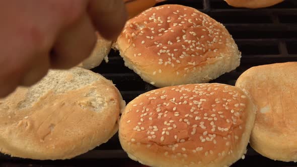 Closeup of Sesame Burger Buns Flipped on the Grill Grid