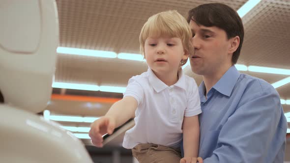 Robot and Child. Boy Looking for Dancing Robot