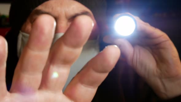 Male wearing virus mask checking contagious contamination with torch light alt