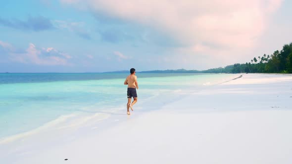 Slow motion: woman on white sand beach turquoise water tropical coastline