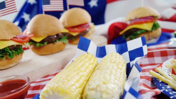 Hamburgers and french fries served on table with 4th july theme