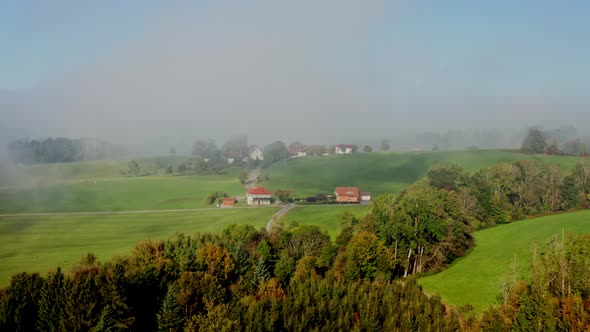 Small town hidden in fog aerial view