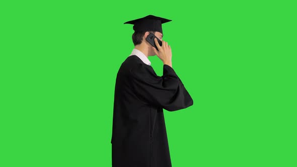 Graduating Student Starts Walking and Making a Call on a Green Screen, Chroma Key.