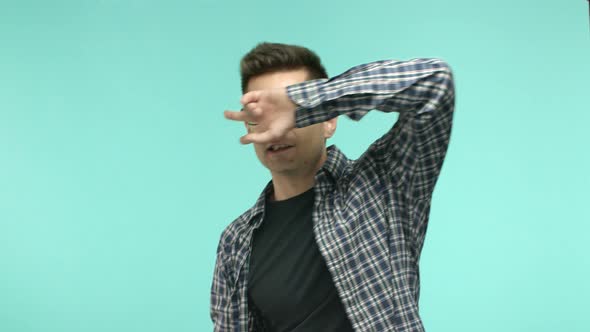 Cheerful Young Man in Glasses Dancing Showing Peace Disco Gesture and Smiling Having Fun Standing