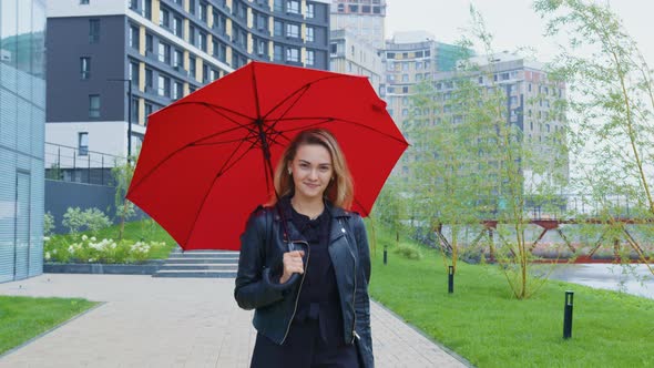 Beautiful Girl Under Red Umbrella Going Smiling