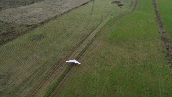 A Takeoff of a Hang Glider From the Field