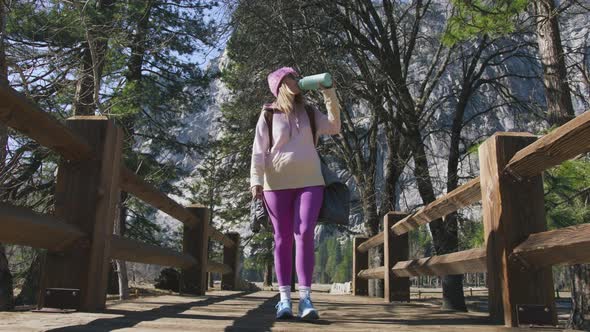 Girl in Fitness Leggings Drinking From Sport Bottle During Hiking Pause Yosemite